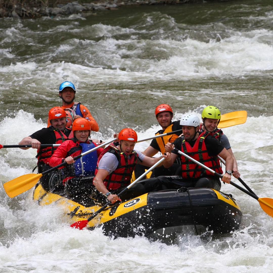 All hands on deck! Team rowing hard at rafting.