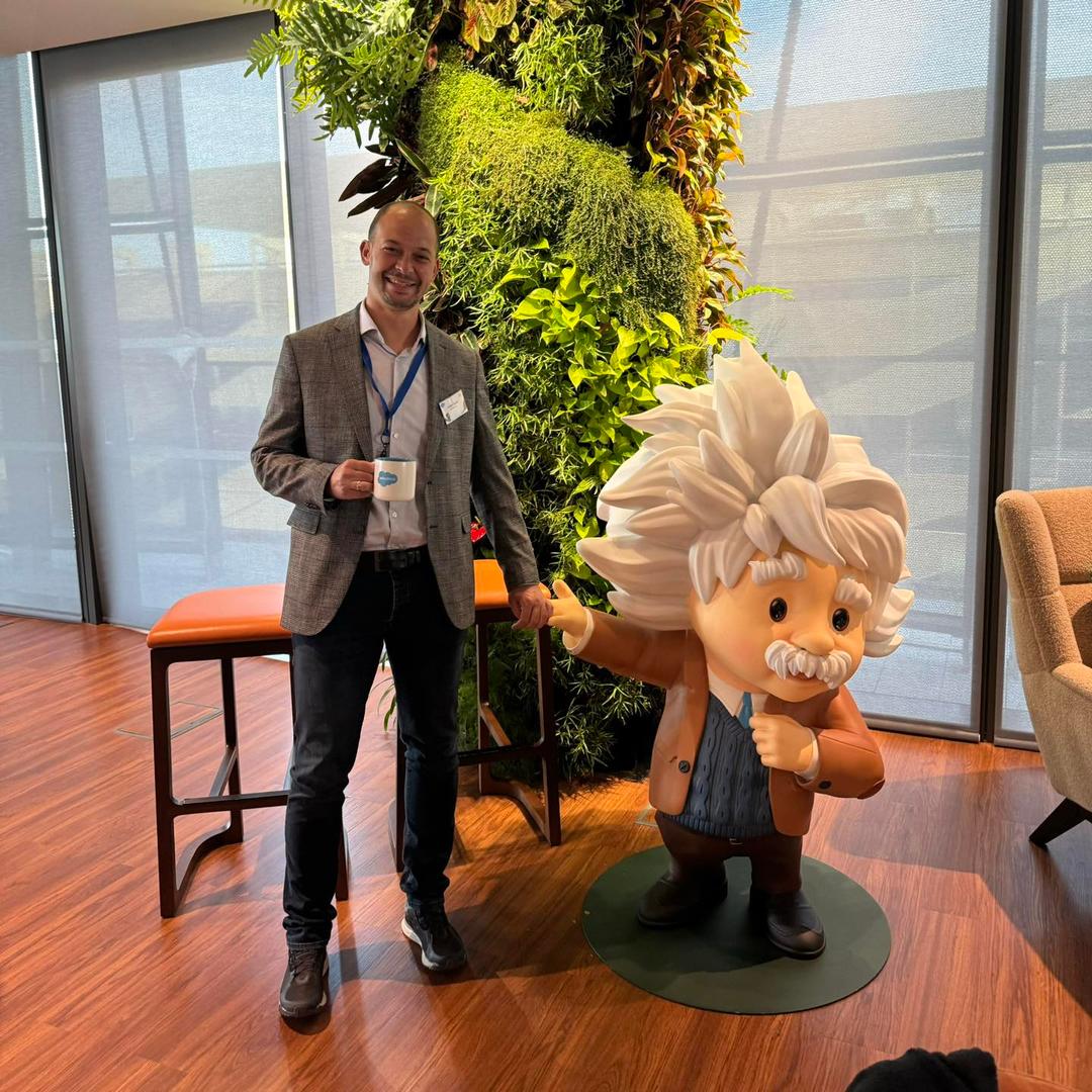 A strong handshake with Salesforce's mascot!